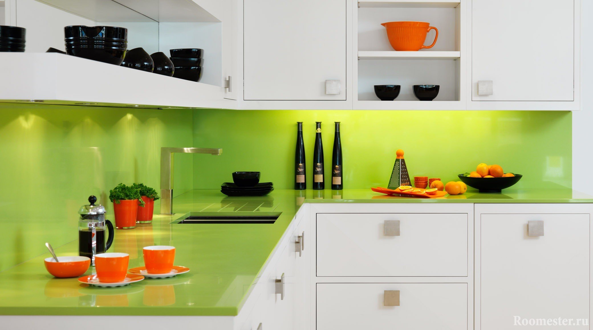 Оранжевая и черная посуда в бело-зеленой кухне