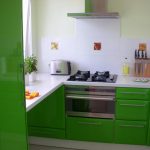 Белая плитка и зеленая мебель на кухне